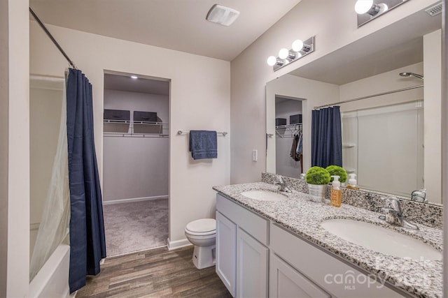 full bathroom featuring wood-type flooring, vanity, toilet, and shower / bath combination with curtain