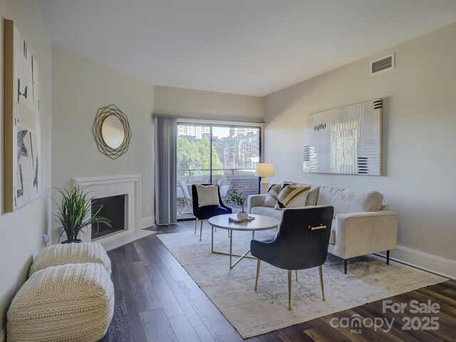 224 N Poplar St Unit 19, Charlotte, NC 28202 - living room with wood finished floors and a fireplace