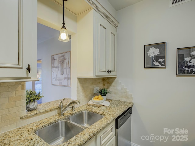 kitchen with decorative backsplash, light stone counters, stainless steel dishwasher, sink, and pendant lighting