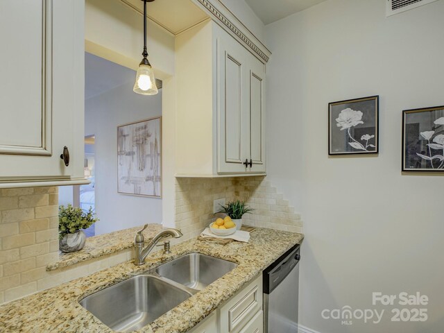 224 N Poplar St Unit 19, Charlotte, NC 28202 - kitchen featuring stainless steel dishwasher, backsplash, light stone countertops, decorative light fixtures, and white cabinetry