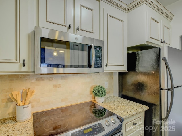 kitchen featuring tasteful backsplash, light stone countertops, and appliances with stainless steel finishes