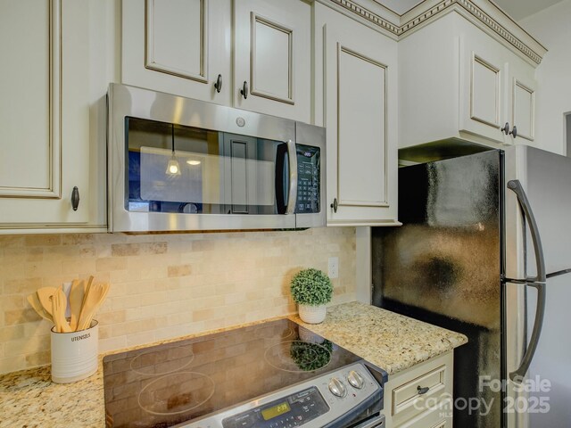 224 N Poplar St Unit 19, Charlotte, NC 28202 - kitchen featuring stainless steel appliances, tasteful backsplash, and light stone countertops