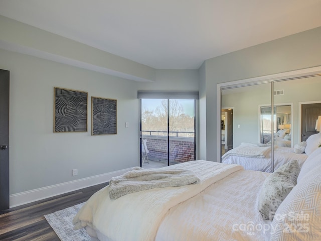 bedroom featuring access to exterior, dark hardwood / wood-style flooring, and a closet