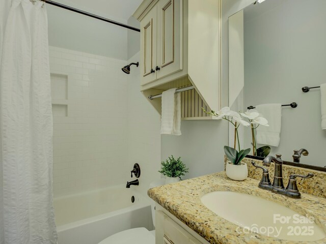 full bathroom with vanity, shower / bath combination with curtain, and toilet