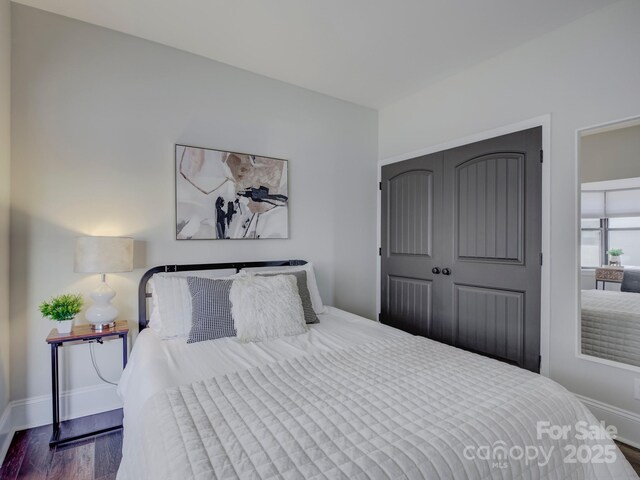 224 N Poplar St Unit 19, Charlotte, NC 28202 - bedroom with wood finished floors and a closet