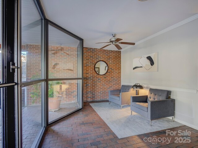 interior space featuring ceiling fan and crown molding