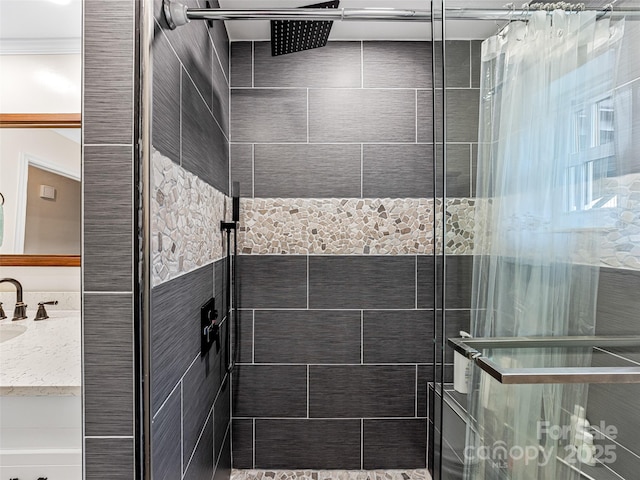 bathroom with a tile shower and vanity