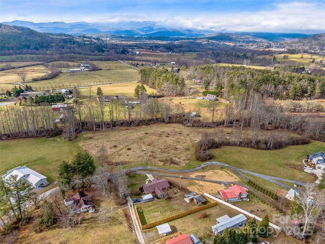 drone / aerial view featuring a mountain view and a rural view