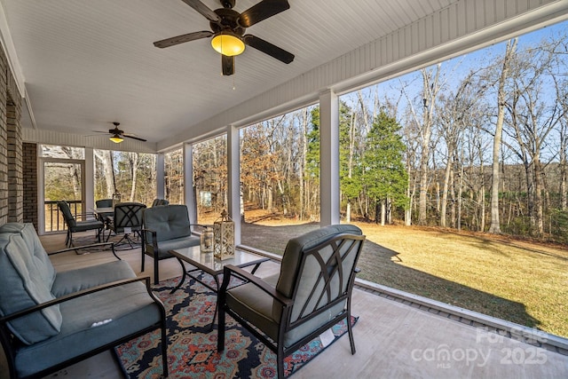 sunroom featuring ceiling fan