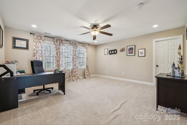 carpeted office featuring ceiling fan