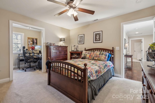 bedroom featuring light carpet and ceiling fan