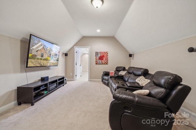 carpeted cinema with lofted ceiling