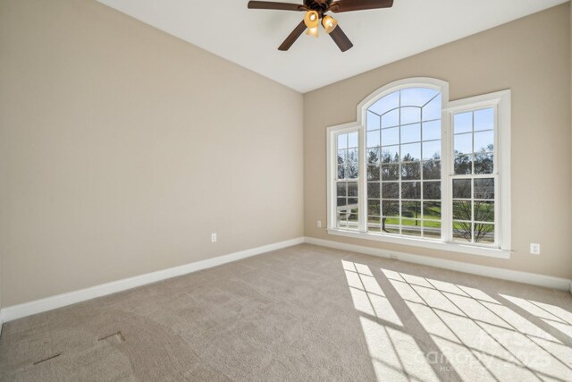 carpeted empty room with ceiling fan