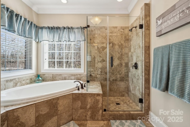 bathroom featuring ornamental molding and shower with separate bathtub