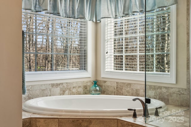 bathroom with a relaxing tiled tub