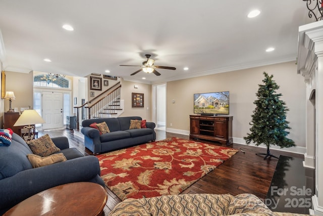 living room featuring dark wood-type flooring, ceiling fan, and ornamental molding