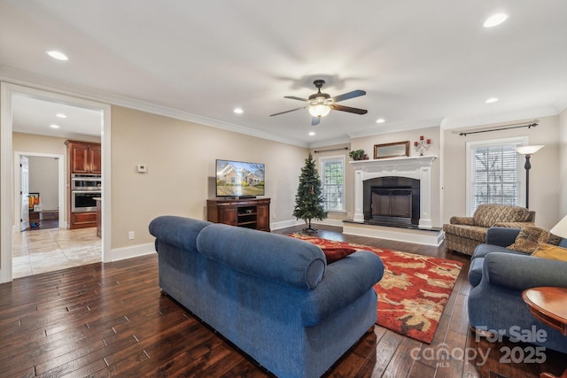 living room with ceiling fan, dark hardwood / wood-style flooring, and ornamental molding