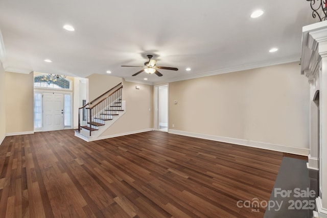 entrance foyer with dark wood-style floors, baseboards, ceiling fan, stairs, and ornamental molding