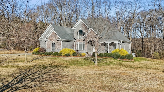 view of front of house with a front lawn and brick siding