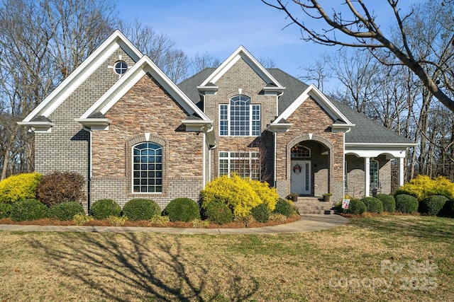 view of front of house with a front lawn and brick siding