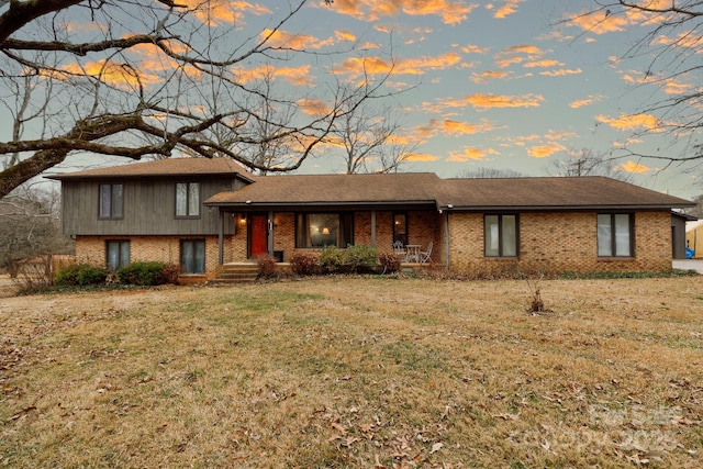 split level home with a lawn