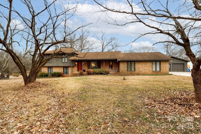 view of front of property featuring a garage and a front lawn