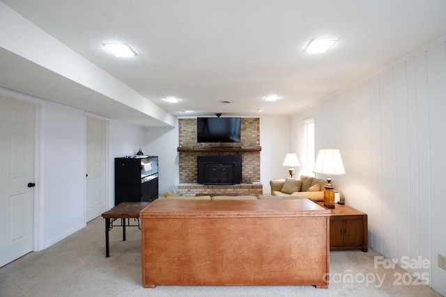 carpeted living room with a brick fireplace