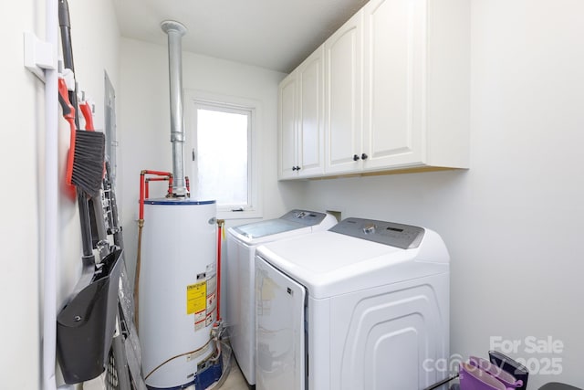 laundry room featuring washing machine and dryer, cabinets, and gas water heater