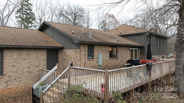 rear view of property with a wooden deck