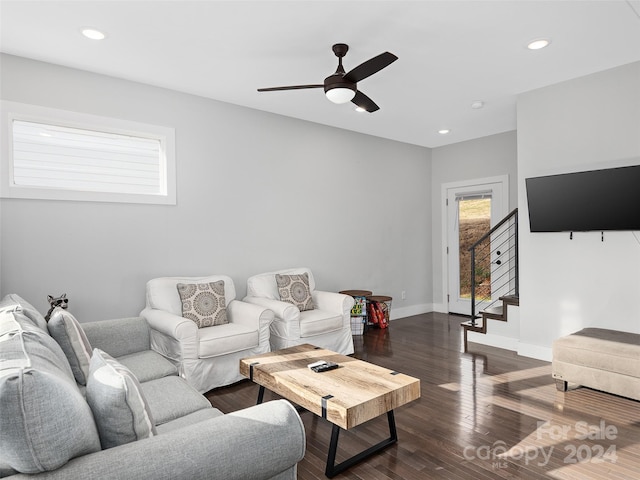 living room with ceiling fan and dark hardwood / wood-style floors