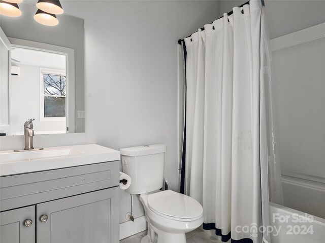 full bathroom featuring tile patterned floors, vanity, toilet, and shower / tub combo