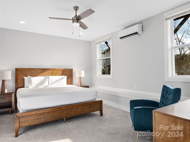 bedroom featuring carpet flooring, ceiling fan, and an AC wall unit