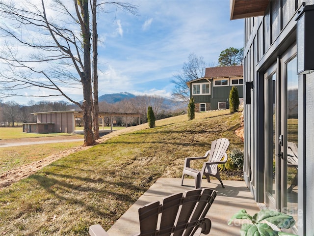 view of yard with a patio area and a mountain view