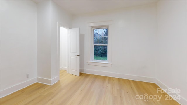 spare room with light wood-type flooring