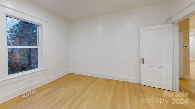 unfurnished room with light hardwood / wood-style flooring