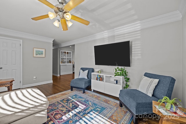 living room with crown molding, ceiling fan, and dark hardwood / wood-style floors