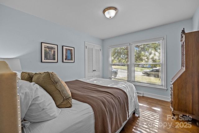 bedroom with a closet and dark hardwood / wood-style flooring