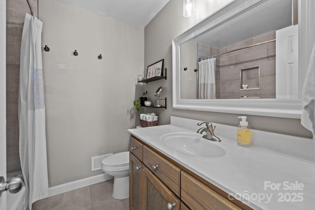 bathroom with tile patterned floors, walk in shower, vanity, and toilet