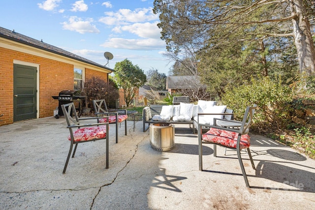 view of patio with an outdoor living space and a grill