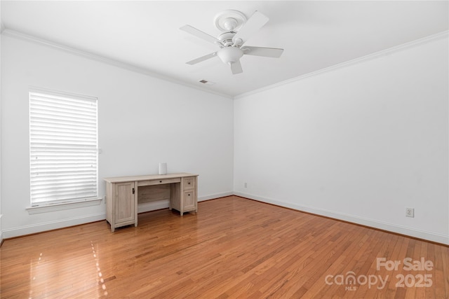 empty room featuring ceiling fan, light hardwood / wood-style floors, and ornamental molding