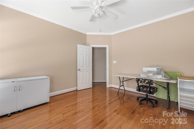 office area with light wood-type flooring, ceiling fan, and ornamental molding