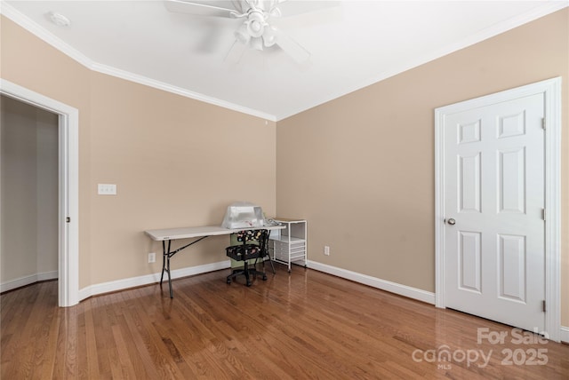 unfurnished office with ceiling fan, wood-type flooring, and ornamental molding