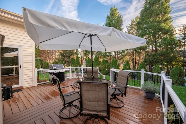 wooden deck featuring a grill