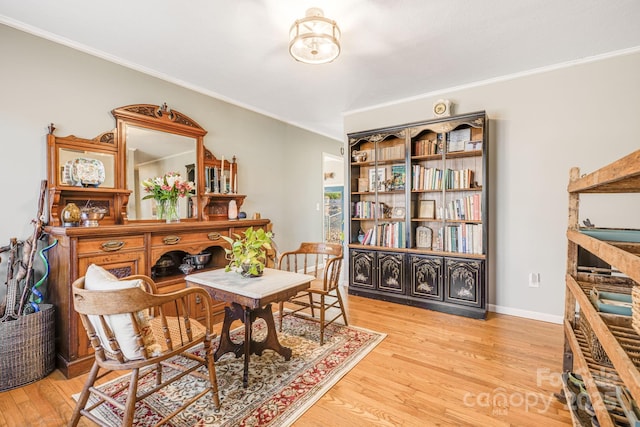 interior space featuring ornamental molding and light hardwood / wood-style floors