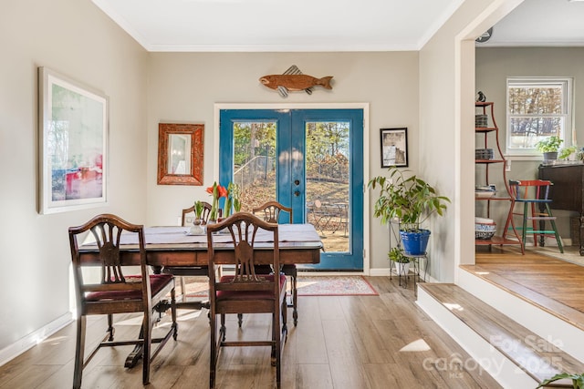 dining room featuring ornamental molding, french doors, and hardwood / wood-style floors