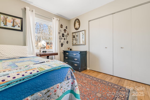 bedroom with light wood-type flooring and a closet