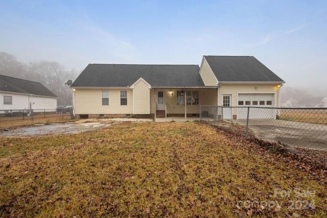 ranch-style home with a front yard and a garage