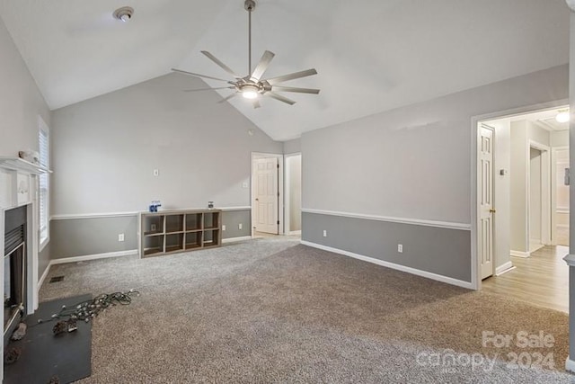 unfurnished living room featuring light colored carpet, ceiling fan, and lofted ceiling