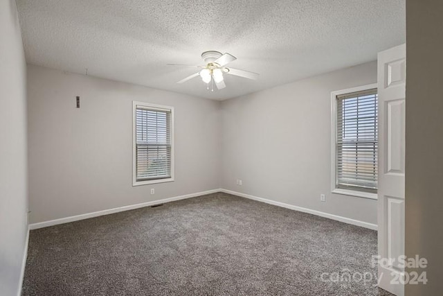 carpeted empty room with a textured ceiling and ceiling fan