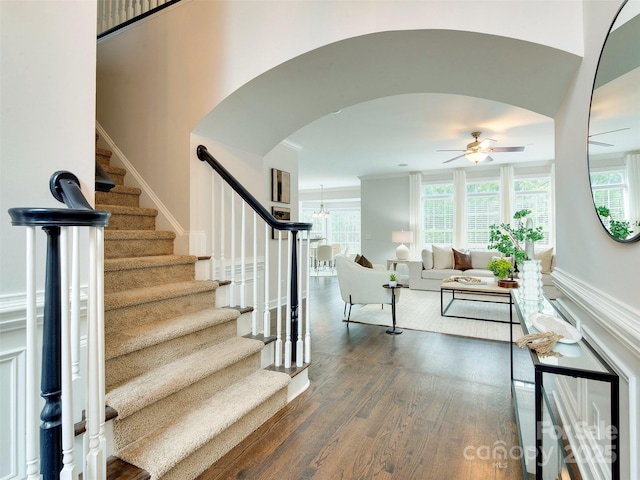 staircase with hardwood / wood-style flooring and ceiling fan